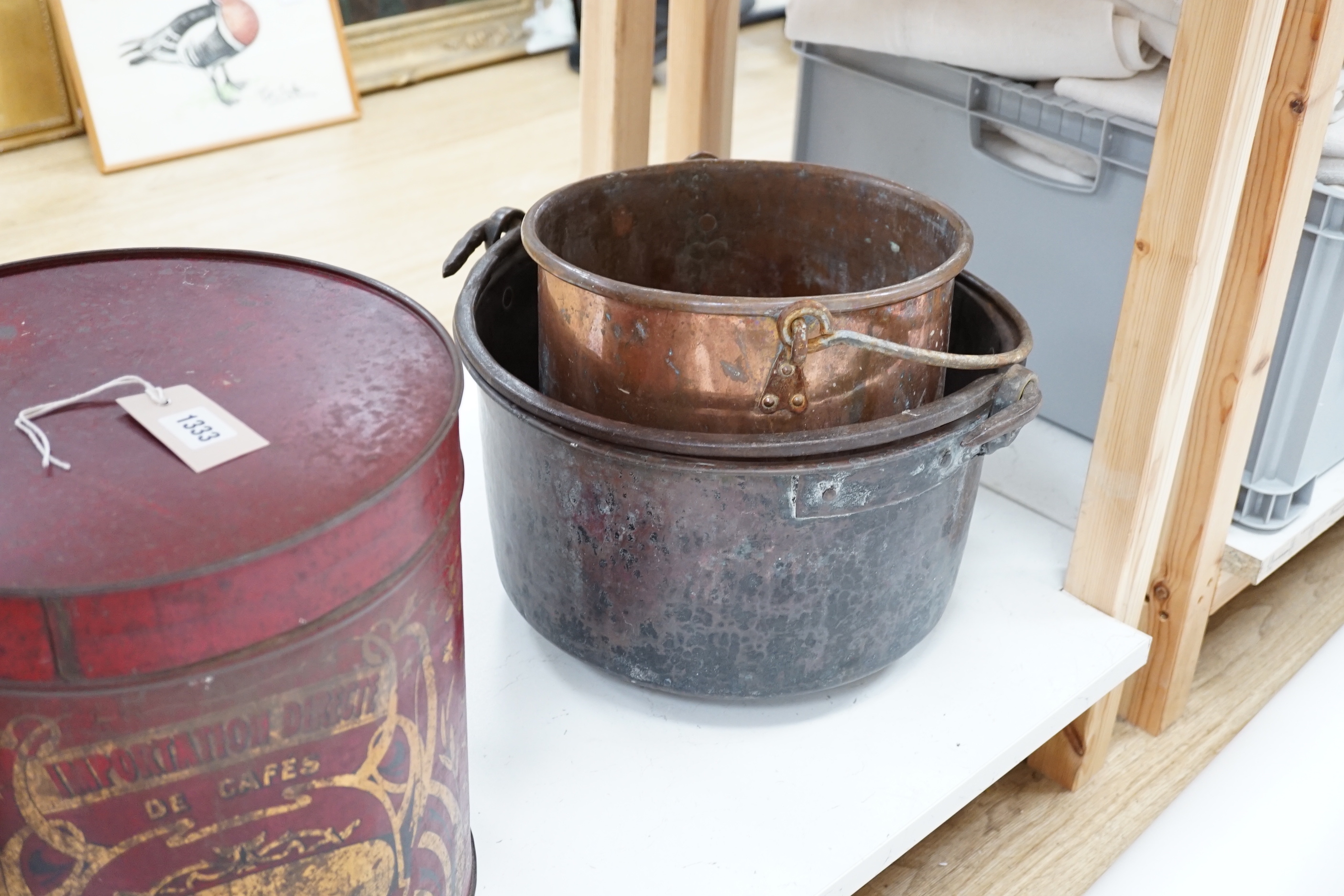 Two copper cauldrons with swing handles, the largest 43cm wide